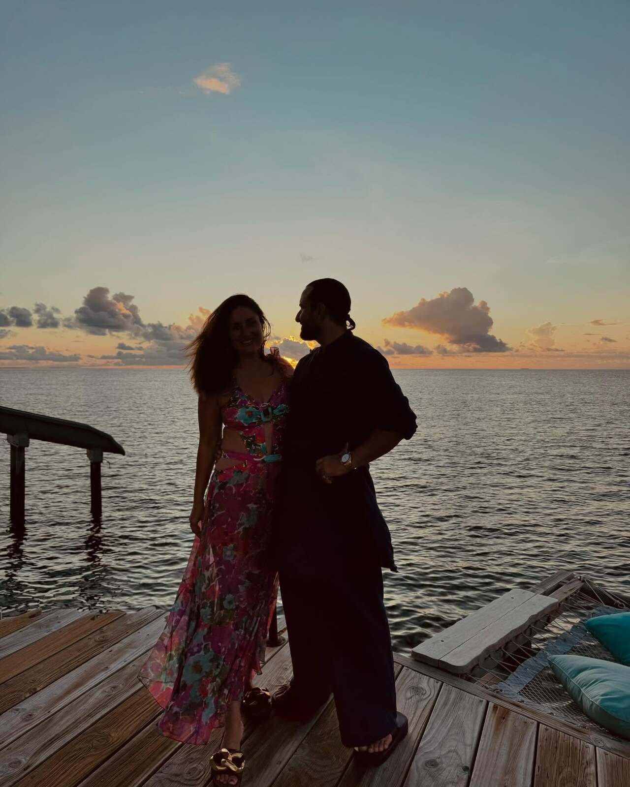 Kareena enjoys a romantic moment with hubby Saif, and she looks drop-dead gorgeous in a long floral beachwear, lovingly gazing at him. 